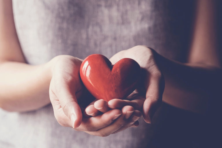 Asian woman holding red heart, health insurance, donation charity concept